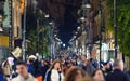 People walk at night along Corso Italia main shopping street of Sorrento, Italy Royalty Free Stock Photo