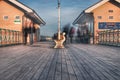 People walk past the bench at penarth peir