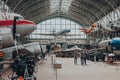 People walk past military and civil aircrafts inside aviation hall of The Royal Museum of the Armed Forces and Military History in
