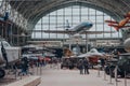 People walk past military and civil aircrafts inside aviation hall of The Royal Museum of the Armed Forces and Military History in