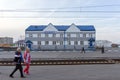 People walk past the office of a large Russian federal state company Russian Post at a railway station in the Siberian city.