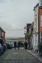 People walk past old houses on Watchbell Street in Rye, England Royalty Free Stock Photo