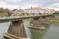 People walk on pedestrian bridge over Uzh river. Uzhhorod, Ukraine