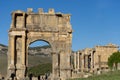 People walk through a Roman arch. Royalty Free Stock Photo