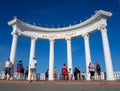 People walk in the rotunda on the central beach of the city of Alushta