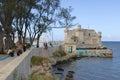 People walk by the sea-front of Cojimar in Cojimar, Cuba.