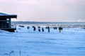People walk on a snow-covered beach in Jurmala, on the shores of the Gulf of Riga, in winter 2021. Latvia