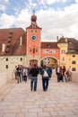 People walk on The Stone Bridge Steinerne BrÃÂ¼cke in Regensburg, Germany