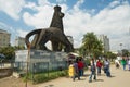 People walk by the street next to the iconic statue of the Lion of Judah in Addis Ababa, Ethiopia.