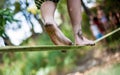 People walk on a tightrope Slackline