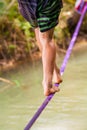 People walk on a tightrope Slackline