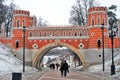 People walk towards an old bridge in Tsaritsyno park in Moscow