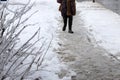 People walk on uncleaned sidewalk, slippery and icy sidewalk Royalty Free Stock Photo