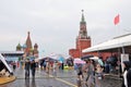 People walk under umbrella at Books of Russia fair.