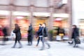 People walking against shop window, zoom effect, motion blur