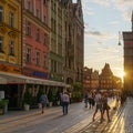 People walking along the market square in the old town of Wroclaw at sunset Royalty Free Stock Photo