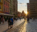 People walking along the market square in the old town of Wroclaw at sunset Royalty Free Stock Photo