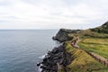 People Walking along the Coast