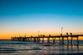 People walking along Glenelg Beach jetty Royalty Free Stock Photo