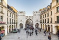 People walking along through the Karlstor gate in Munich