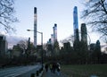 people walking along a path with trees on both sides in a city Royalty Free Stock Photo