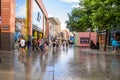 People walking along a pedestrian street lined with shops and restaurants in Liverpool city centre