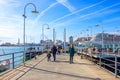 People walking along the piers of the ancient port in Genoa, Italy Royalty Free Stock Photo