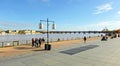 People walking along the Quai Richelieu on the bank of the Garonne river through the city of Bordeaux, France