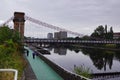 People walking along river Clyde, under South Portland Street bridge in Glasgow