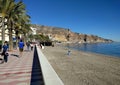 People walking along the seafront promenade of Aguadulce. Spain