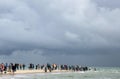 People walking along the seashore at cape Grene, Skagen Odde, Denmark. Overcast sky.