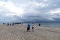 People walking along the seashore at cape Grene, Skagen Odde, Denmark. Overcast sky.