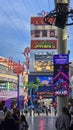 People walking along the street at the Fremont Street Experience with restaurants and retail stores and a video screen ceiling