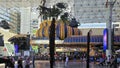 People walking along the street at the Fremont Street Experience with restaurants and retail stores and a video screen ceiling