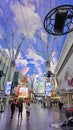 People walking along the street at the Fremont Street Experience with restaurants and retail stores and a video screen ceiling