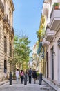 People walking along street of old city Havana, Cuba. Cannon barrels like barrier for cars Royalty Free Stock Photo