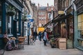 People walking amongst shops on the Flask Walk in Hampstead, London, UK