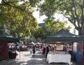 People walking around Agora Square, during a weekend fair on a sunny autumn day