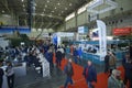 People walking around during exhibition, stands set at the hall