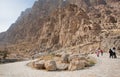 People walking around the massive mountain park in desert valley