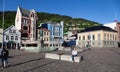 People walking around the Norges bank, Norway's central bank in and Ludvig Holberg statue in Bergen Royalty Free Stock Photo