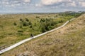 People walking on boardwalk, Wittdun dunes, Amrum island, North Frisia, Schleswig-Holstein, Germany Royalty Free Stock Photo