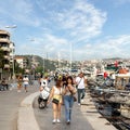 People walking by the Bosphorus between Bebek and Hisari districts, beside docked boats and yachts, Istanbul, Turkey Royalty Free Stock Photo