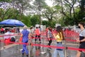 People walking briskly in the rain to join the queue to visit the Istana, during the Open House. The public is