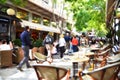 People walking in a busy pedestrian street with cafÃÂ©s in the district of Plaka, Athens, Greece Royalty Free Stock Photo