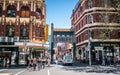 People walking and Chinatown entrance arches on Little Bourke Street in Melbourne Australia