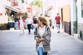 People walking in the city and tourist concept lifestyle with cheerful and trendy adult woman enjoying the town and shopping time