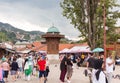 People walking close to Sebilj fountain in Pigeon Square, Bascarsija, Sarajevo, Bosnia and Herzegovina.