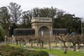 People walking in the courtyard at Golden Gate Park with lush green trees, grass and plants in San Francisco California Royalty Free Stock Photo