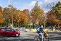 People walking and cyclists against the background of bright autumn trees on the city street. Paris, France, 13/10/2019